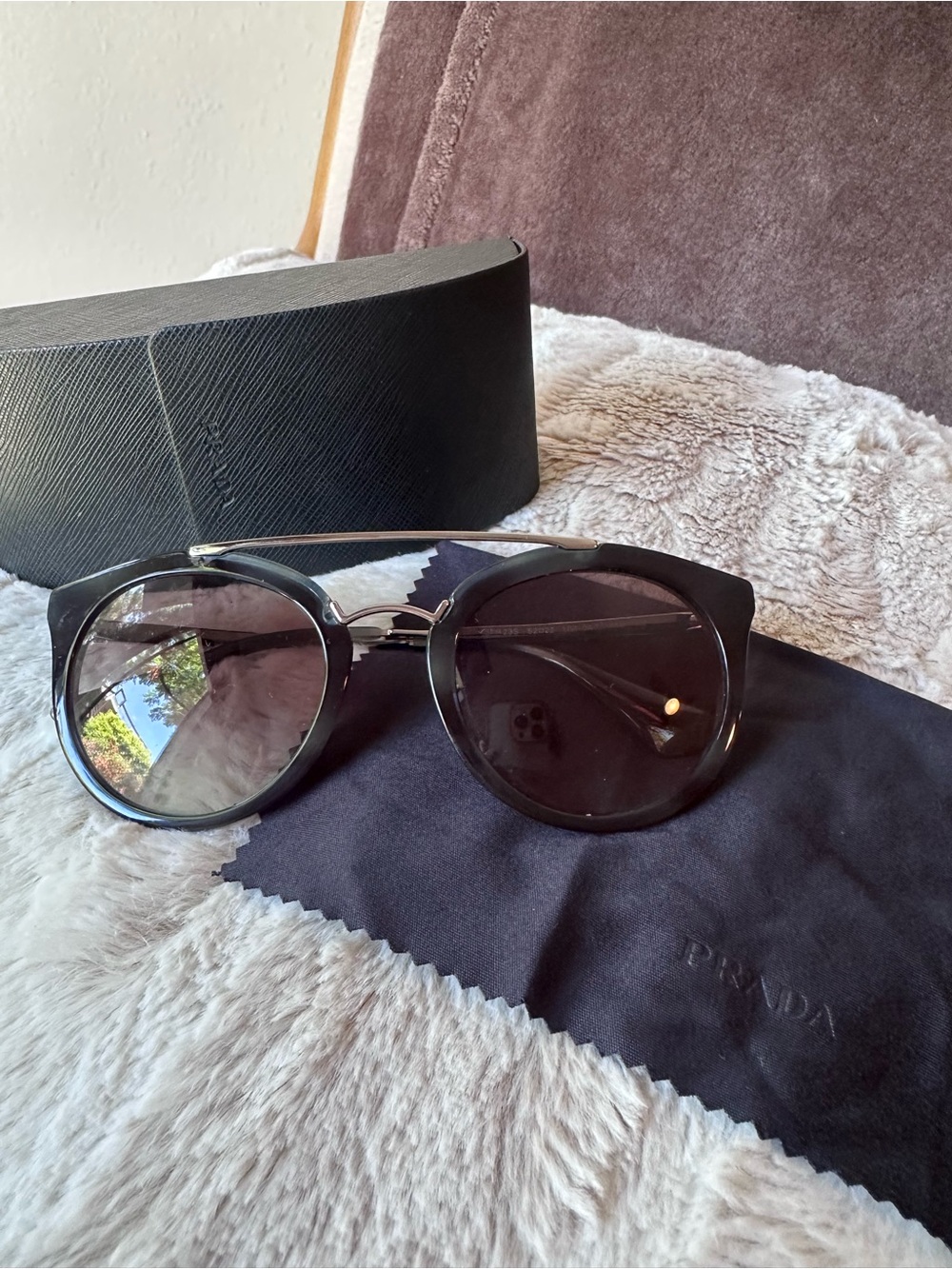 Prada Women’s Black Round Sunglasses with Silver Bridge